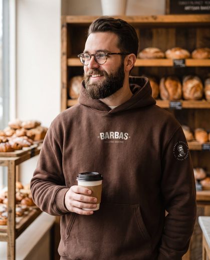 Hombre con sudadera café de la marca Barbas en una panadería